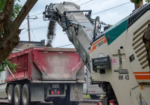 Asphalt milling machine feeding into a dump truck • Photo by Mary-Ann Zykin