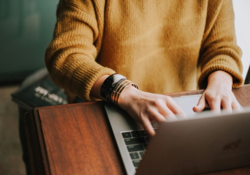 Hands typing on a laptop.