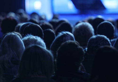 Group of people listening to a presenter.