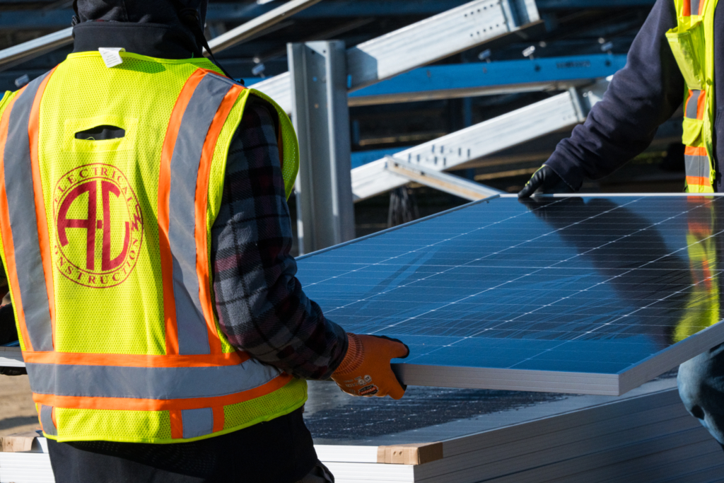 Workers carrying a solar panel