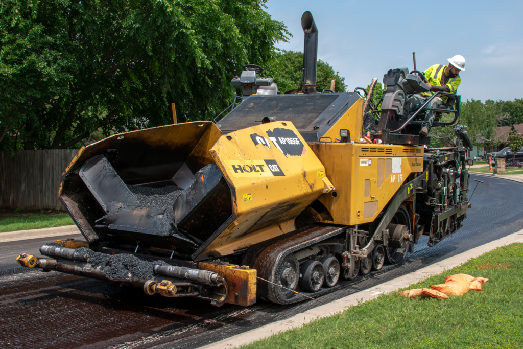 Construction worker paving a road