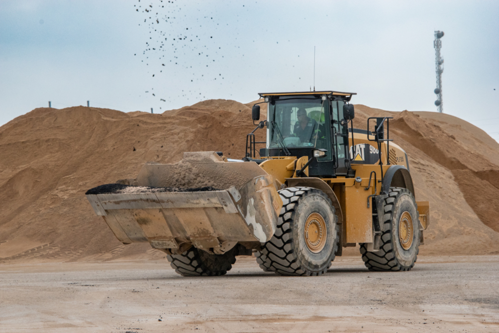 Construction loader moving aggregate