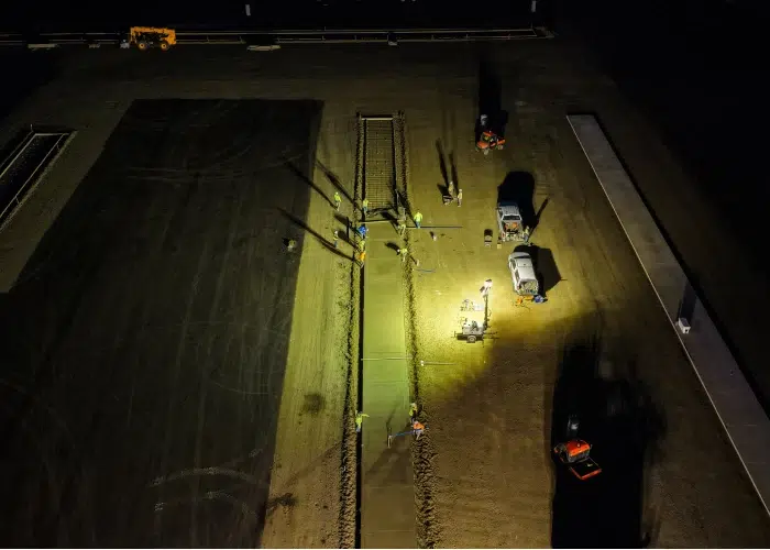 Aerial view of concrete construction crew pouring a concrete slab