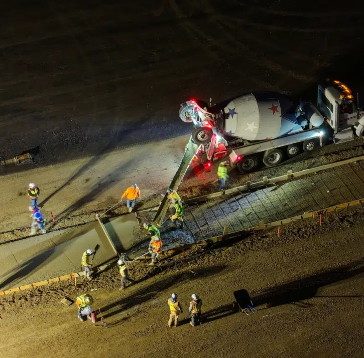 Aerial view of concrete construction crew pouring a concrete slab