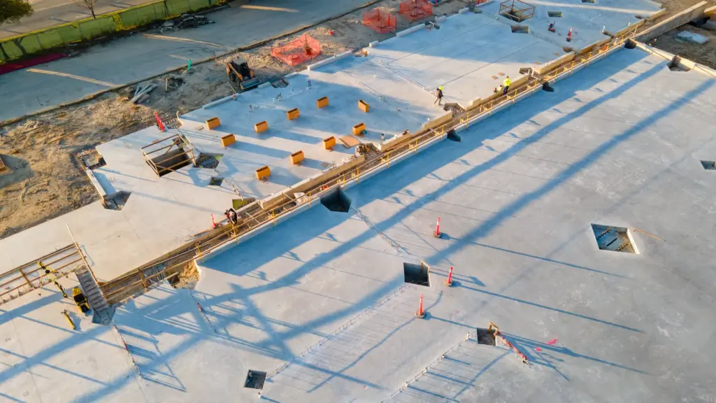 An aerial view of a construction site with workers and equipment.