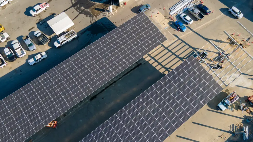 An aerial view of solar panel carports installed at a car dealership.