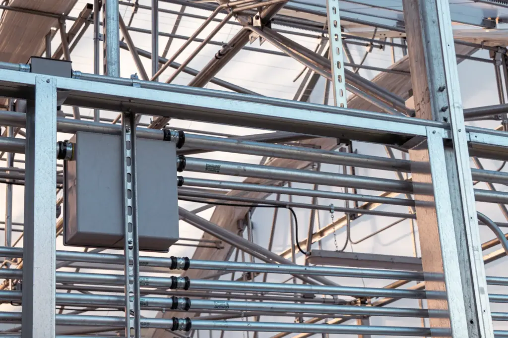 Electrical conduits and control box at an agricultural facility.