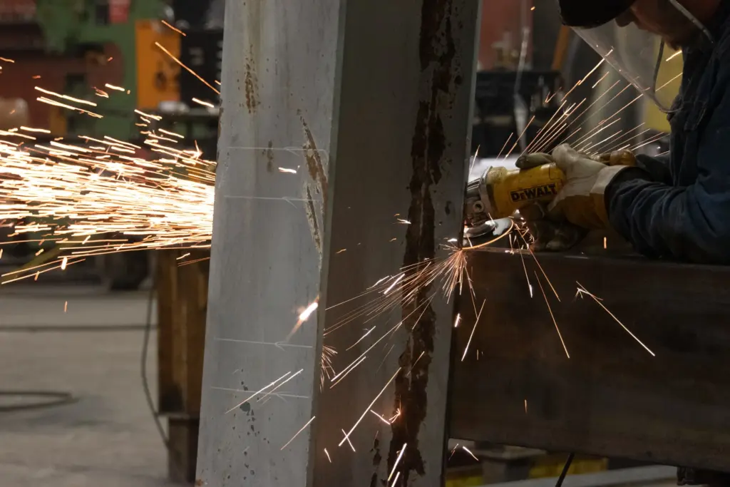 A person is welding with sparks flying around them.
