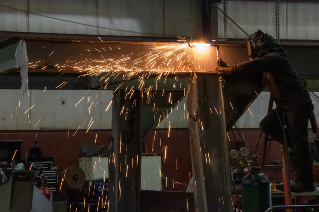 A person welding with sparks flying around them.