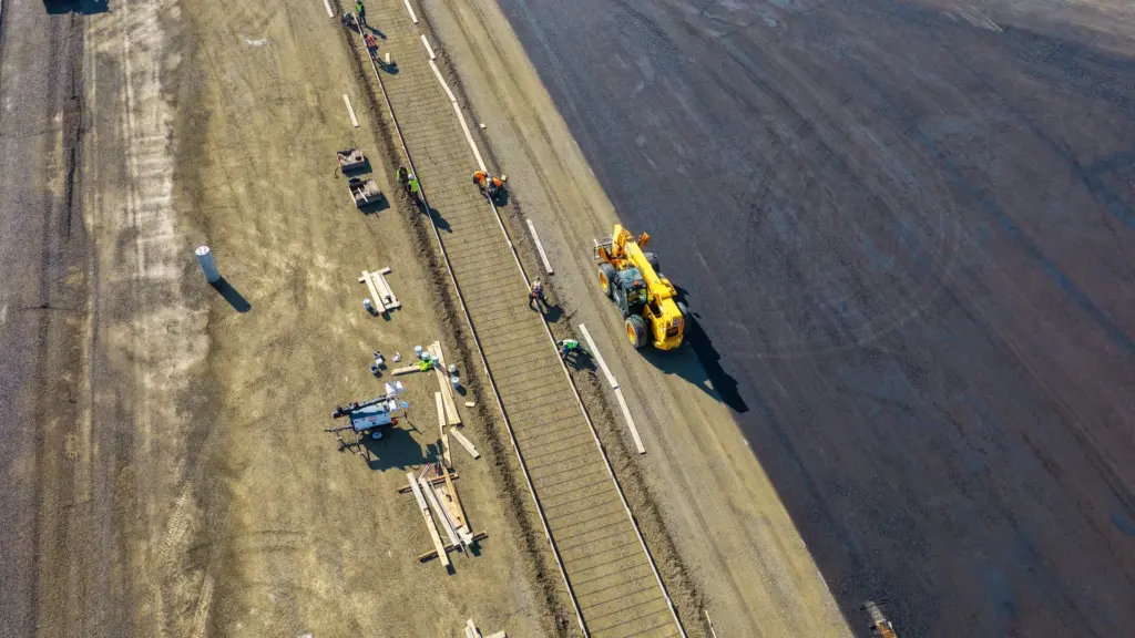 An aerial view of a construction site with workers and equipment.