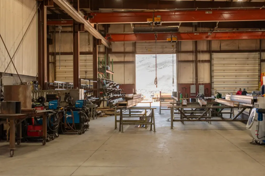 The photograph of an industrial workshop with various equipment scattered throughout.