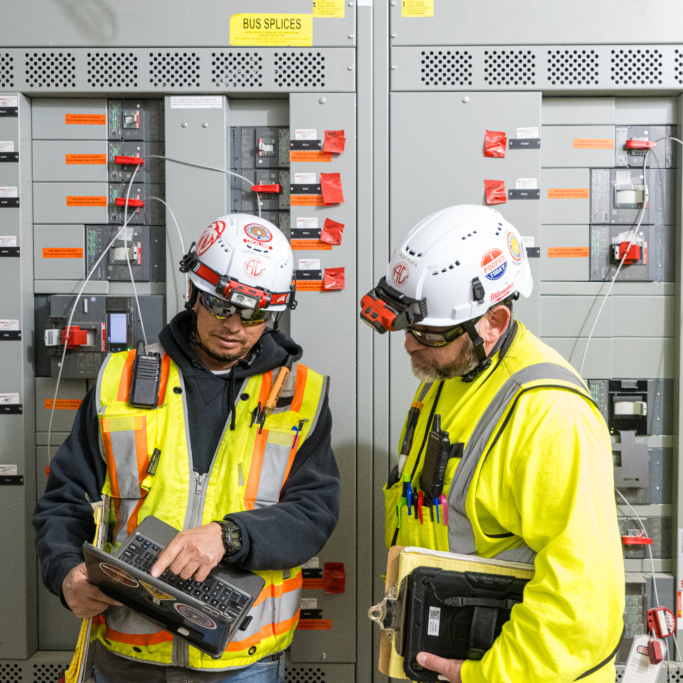Electrical workers having a conversation